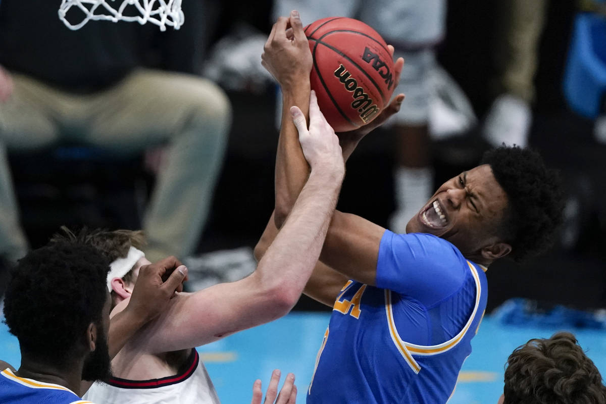 UCLA guard Jaylen Clark, right, fights for a rebound with Gonzaga forward Drew Timme, left, dur ...
