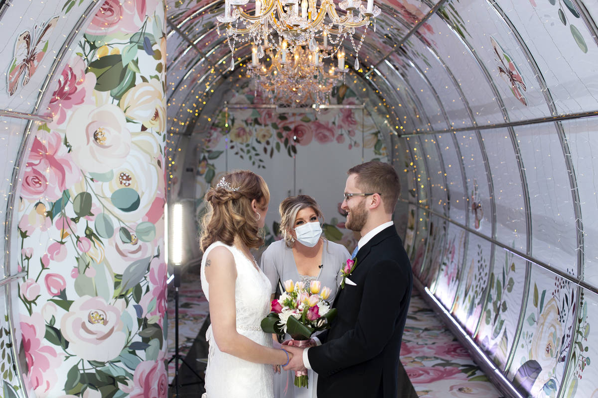 Angie Kelly officiates the wedding of Morgan Sheets and Kyle Kingdon at the Crimson in Bloom po ...