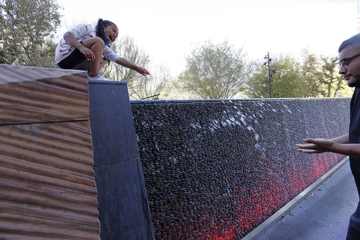 Maia Olivas, 6, of Houston, Texas cools off near the water walls with her father Juan at The Pa ...