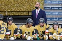 Vegas Golden Knights head coach Pete DeBoer, center, looks up during the second period of an NH ...