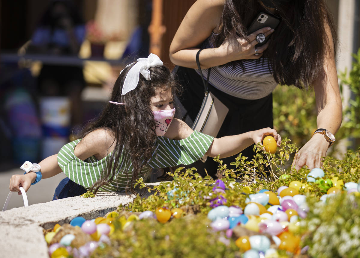 Jaclyne Herrera, left, 4, and Vivian Leby hunt for Easter eggs during an Easter egg hunt and ca ...