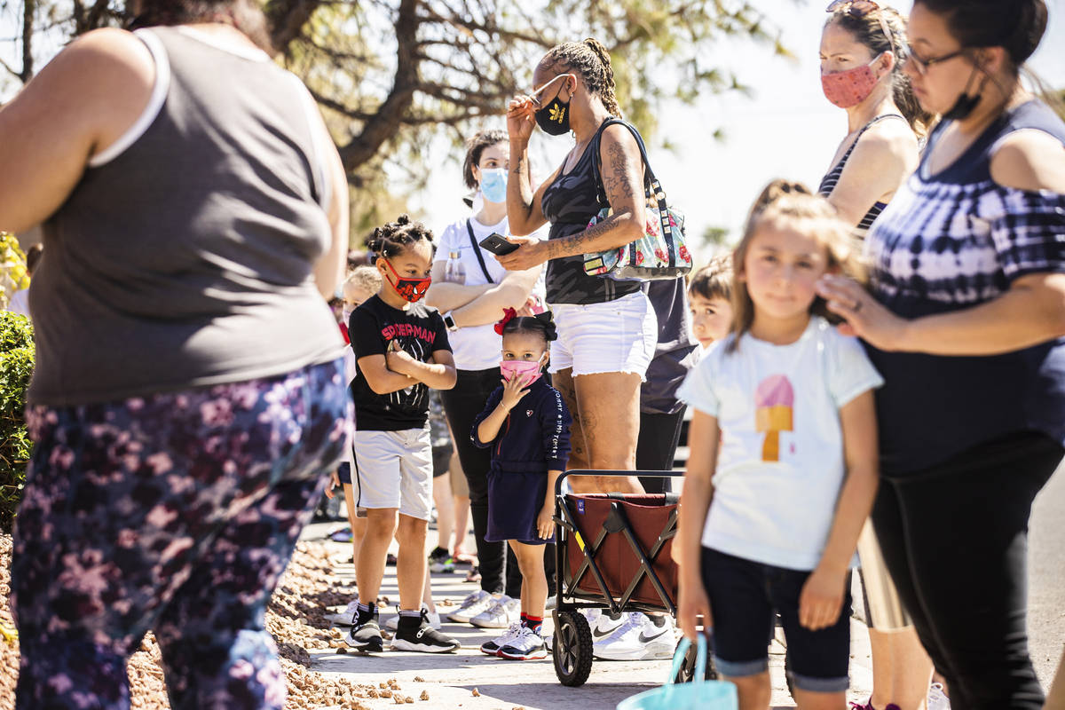 People wait to check in to an Easter egg hunt and carnival sponsored by The JET Foundation, whi ...