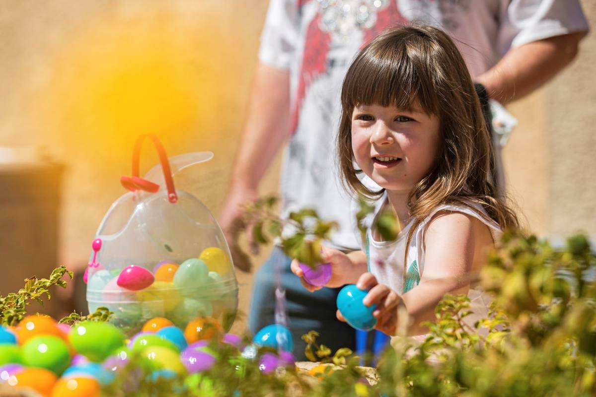 Athena Freeman, 5, collects Easter eggs during an Easter egg hunt and carnival sponsored by The ...