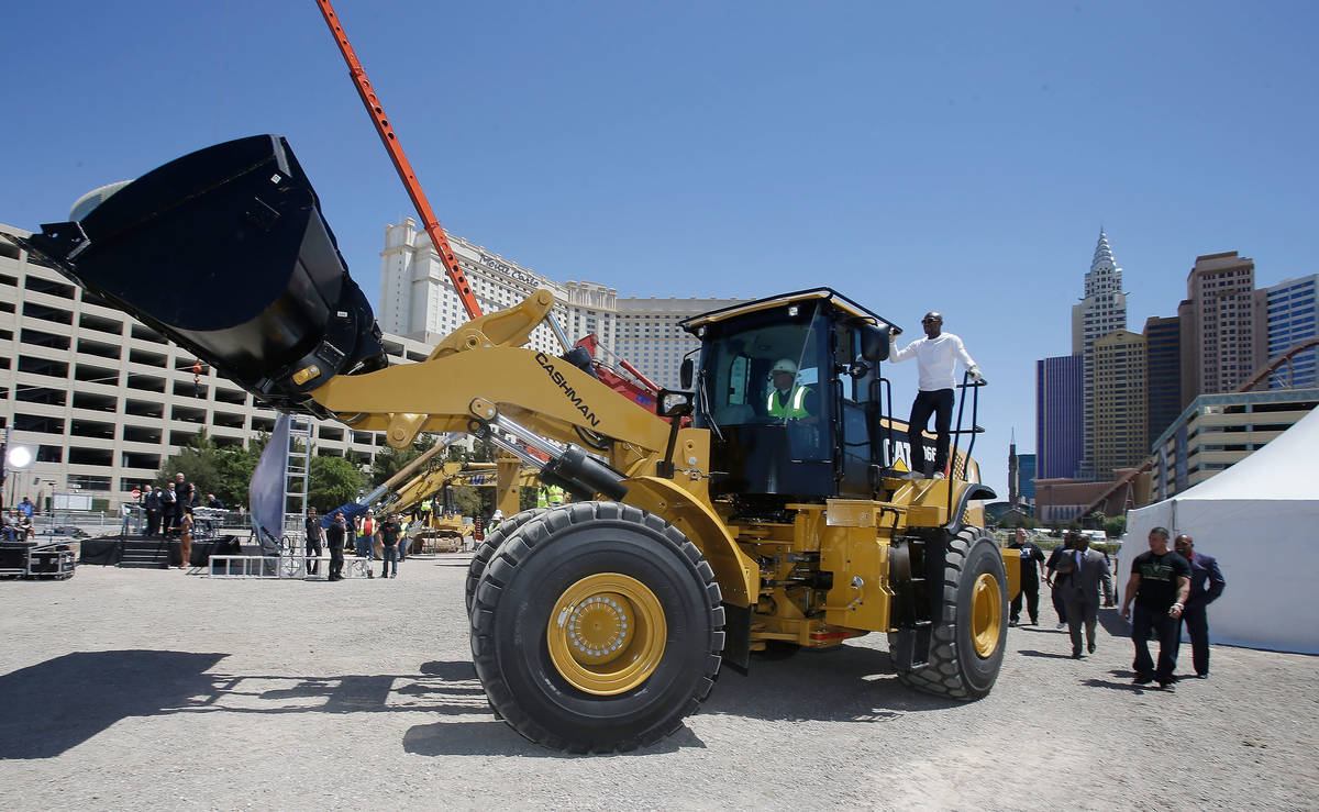 WBC welterweight champion Floyd Mayweather Jr. arrives on a bull dozer during a groundbreaking ...