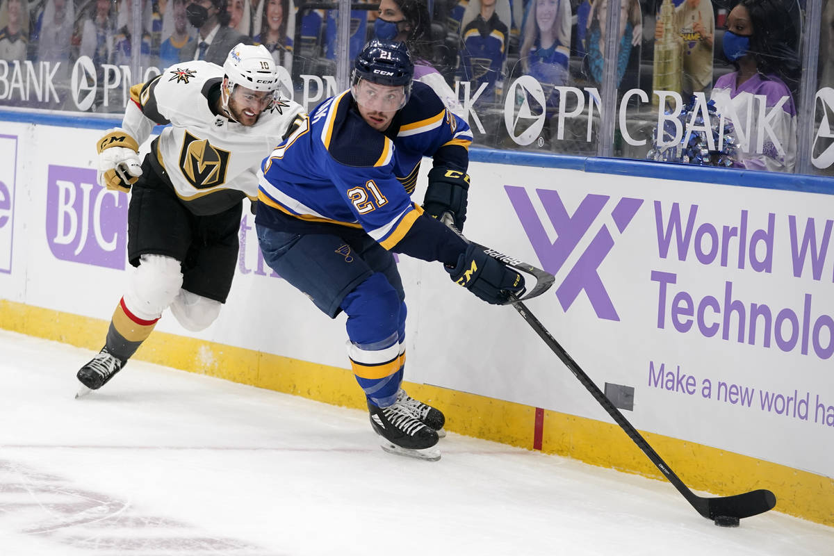 St. Louis Blues' Tyler Bozak (21) controls the puck as Vegas Golden Knights' Nicolas Roy (10) d ...