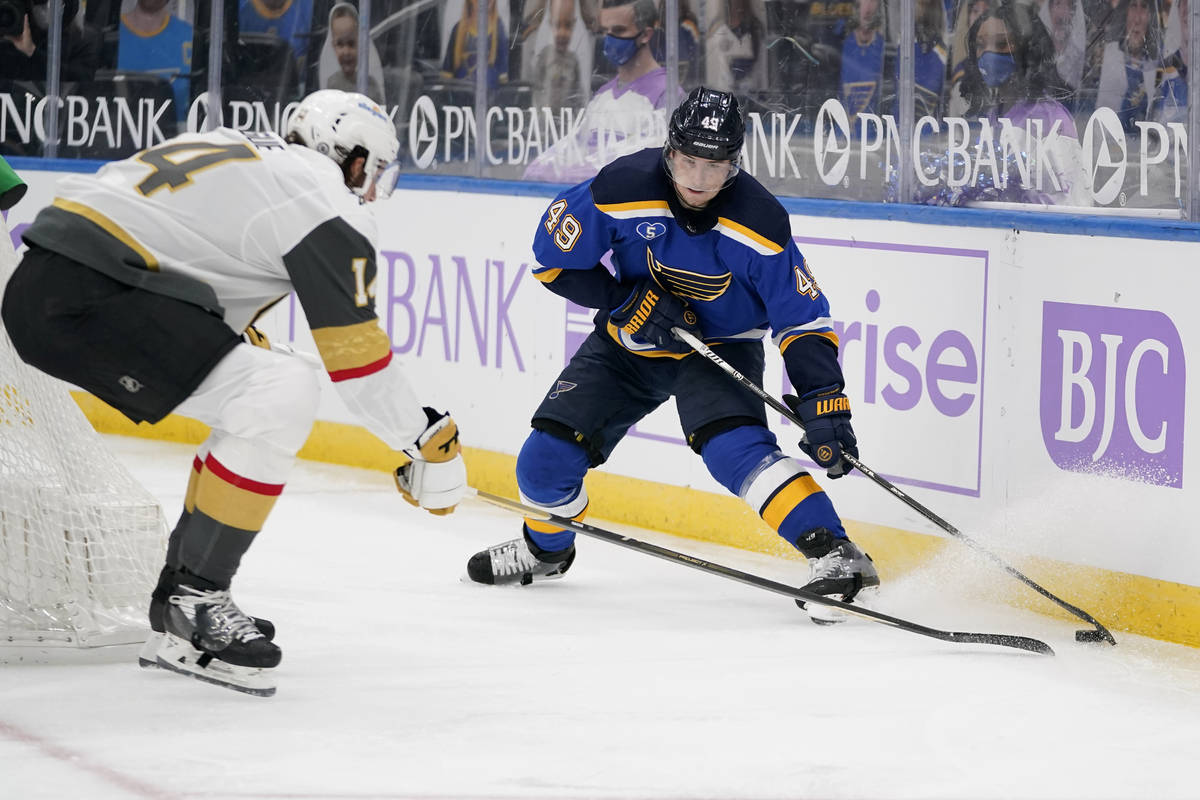 St. Louis Blues' Ivan Barbashev (49) controls the puck as Vegas Golden Knights' Nicolas Hague ( ...