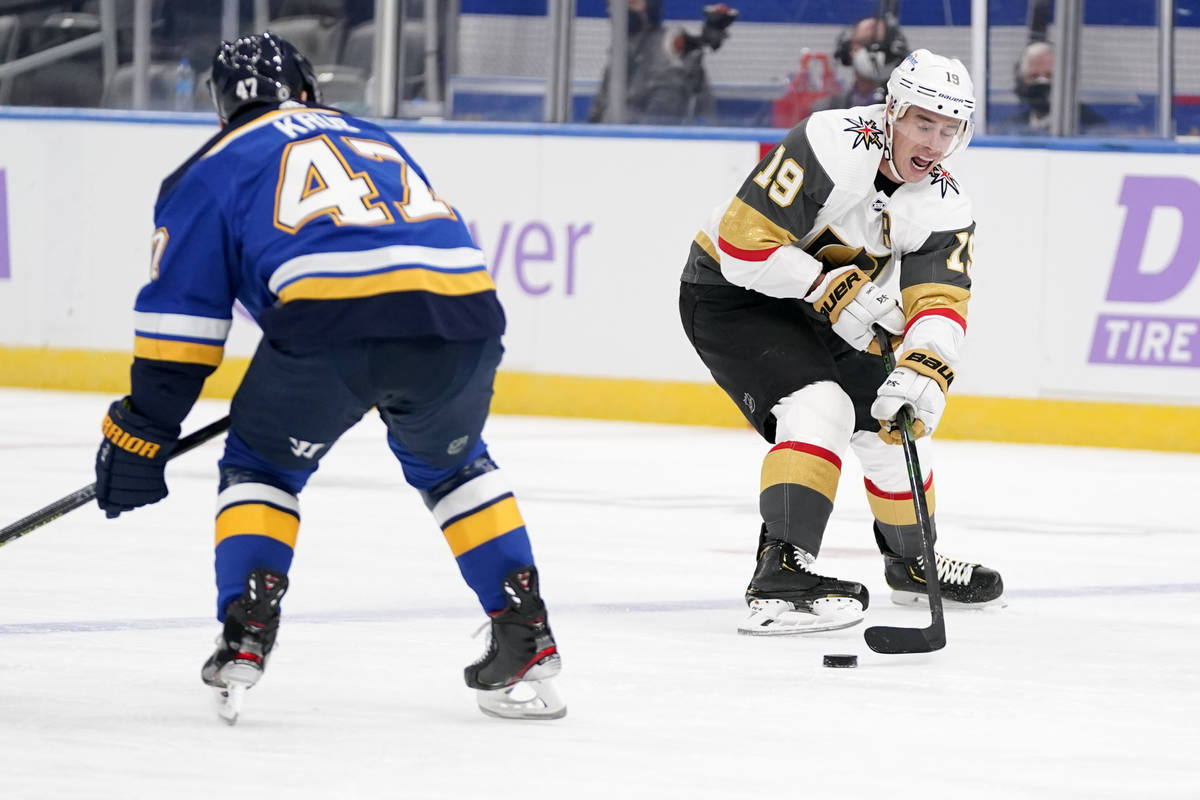 Vegas Golden Knights' Reilly Smith (19) passes around St. Louis Blues' Torey Krug (47) during t ...