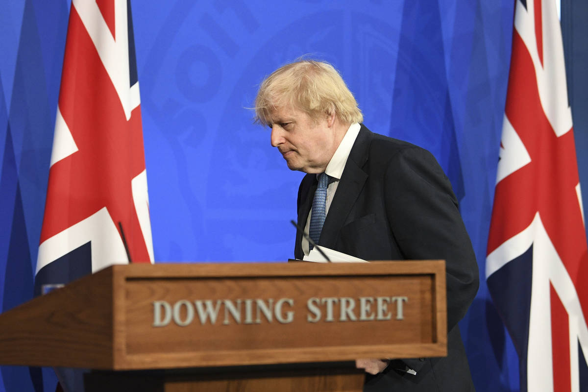 Britain's Prime Minister Boris Johnson leaves, after a coronavirus briefing in Downing Street, ...