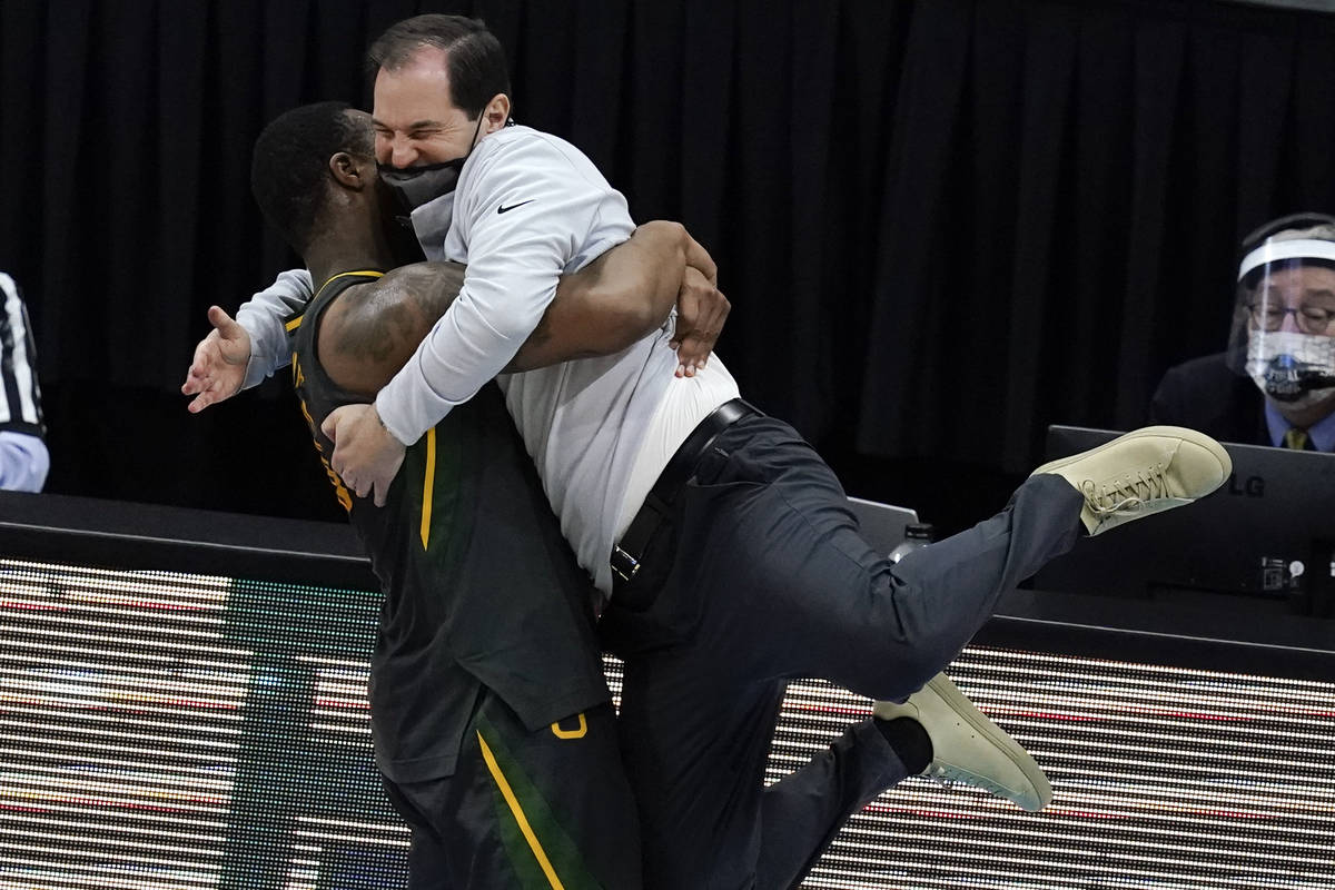 Baylor head coach Scott Drew gets a hug from guard Mark Vital at the end of the championship ga ...