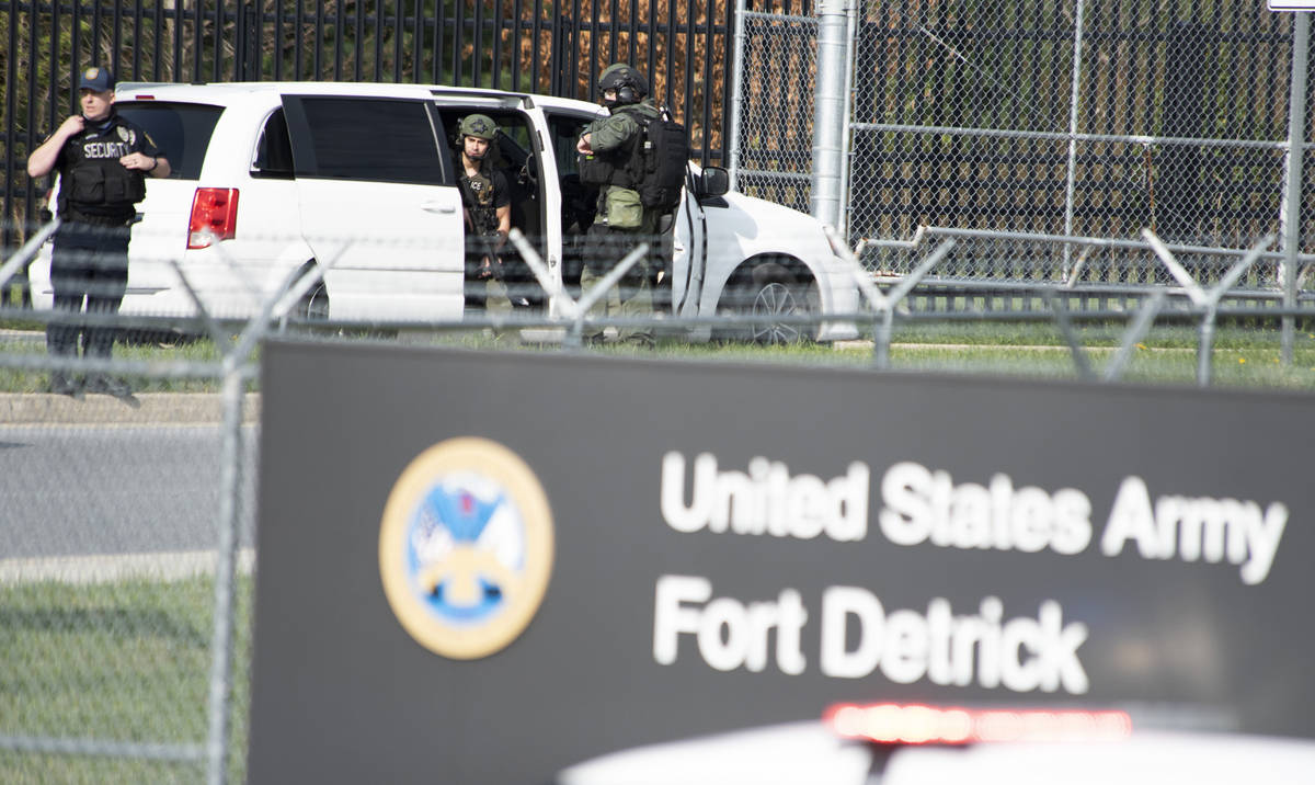 Members of the Frederick Police Department Special Response Team prepare to enter Fort Detrick ...