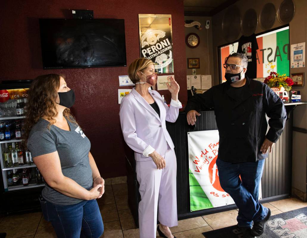 Rep. Susie Lee speaks as Vincenzo Cimino, right, owner of Vinny's Pizzeria, and his wife Tina l ...
