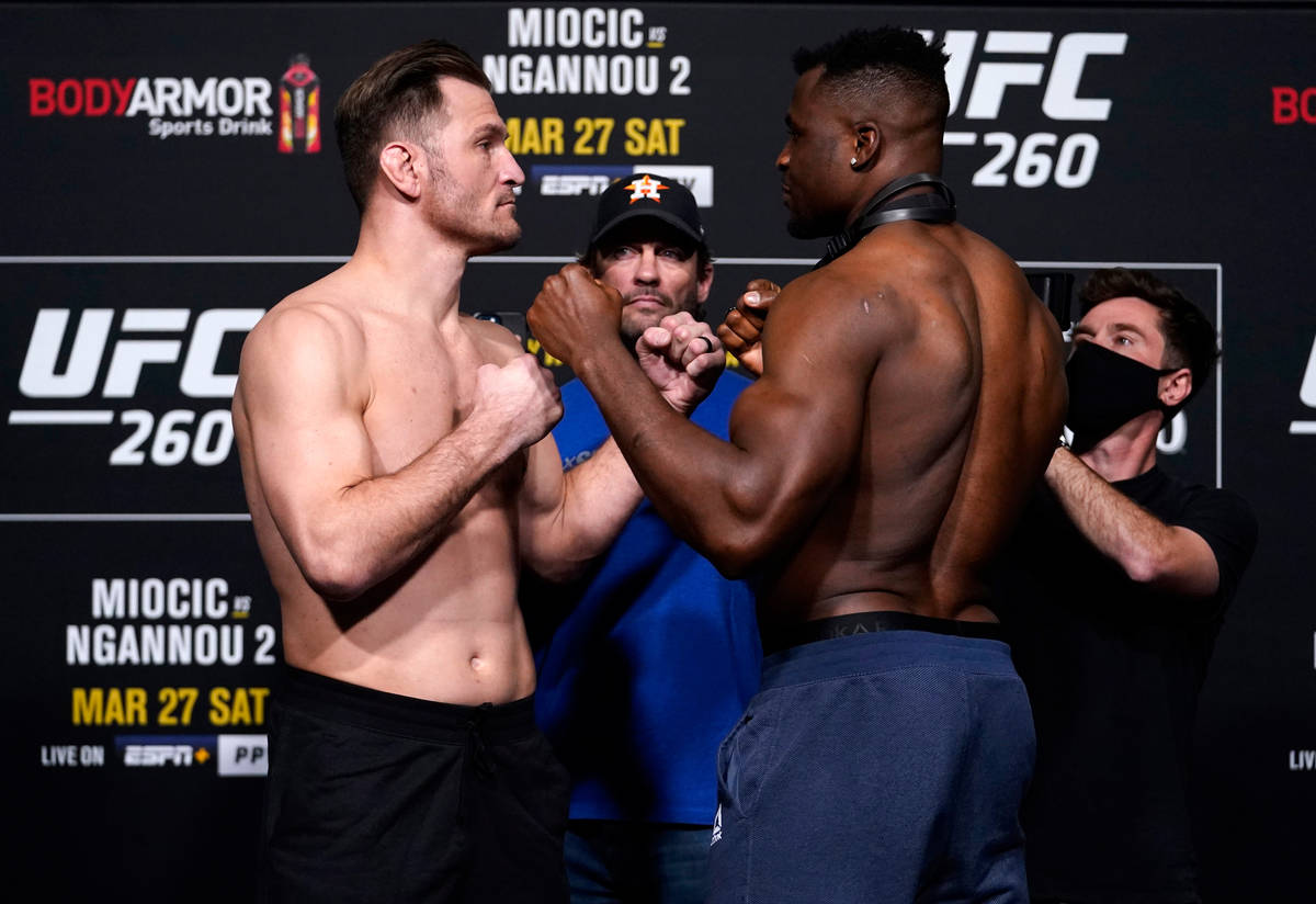 Stipe Miocic and Francis Ngannou face off during the UFC 260 weigh-in at UFC APEX on March 26, ...