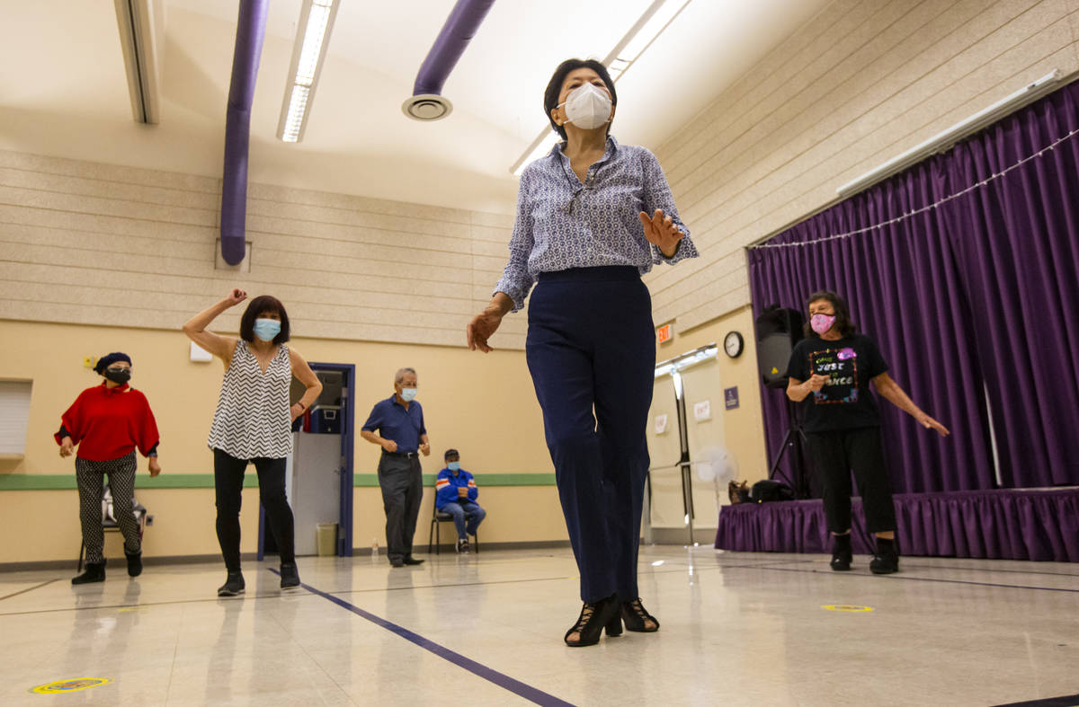 May San Carment, 73, center, participates during a line dancing class at the West Flamingo Seni ...