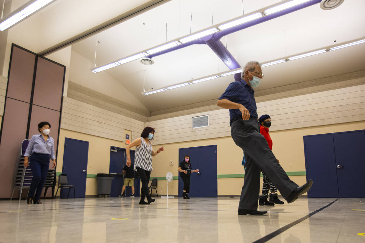 Tom Liao, 80, participates during a line dancing class at the West Flamingo Senior Center durin ...