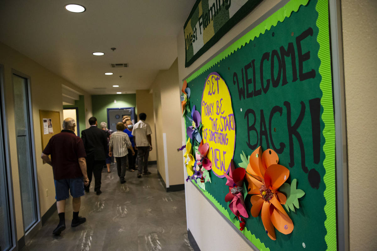 A sign welcomes people back at the West Flamingo Senior Center during the first day that Clark ...