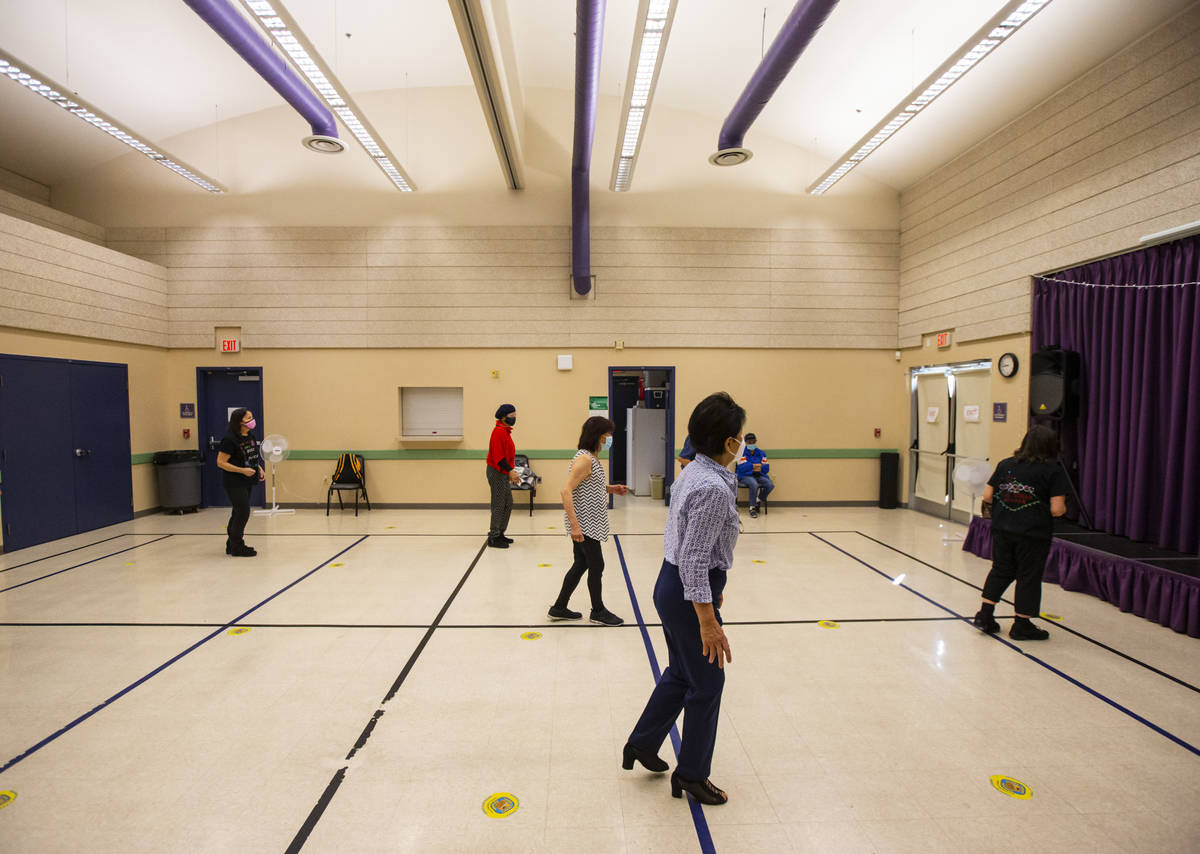 People participate during a line dancing class at the West Flamingo Senior Center during the fi ...
