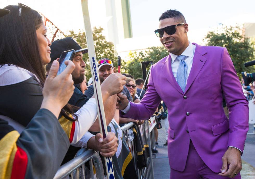 Golden Knights' Ryan Reaves signs autographs on the gold carpet after arriving for the NHL seas ...