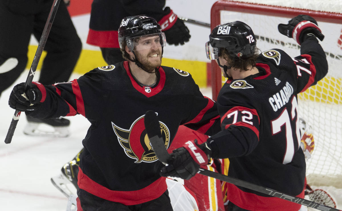 Ottawa Senators center Chris Tierney, left, celebrates his game winning goal with defenseman Th ...