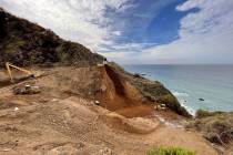 A Caltrans construction crew repairs a section of Highway 1 along the Pacific Ocean in Big Sur, ...