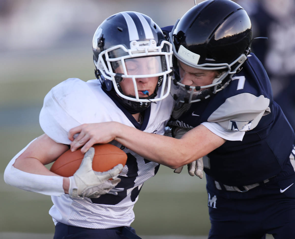 White Pine's Isaac Fitzsimmons (33) is tackled by Meadows' Sean Gosse (7) in the second quarter ...