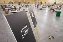 Signs indicate the Pfizer COVID-19 vaccine at a new site at Mandalay Bay Convention Center on W ...
