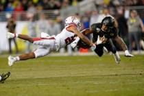 In this Dec. 6, 2018, file photo, Oregon safety Jevon Holland (8) breaks up a pass for Utah wid ...