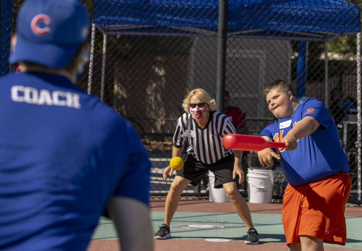 Batter Noah Boruchowitz connects on a pitch from coach Guy Tannenbaum as umpire Carrie OÕD ...