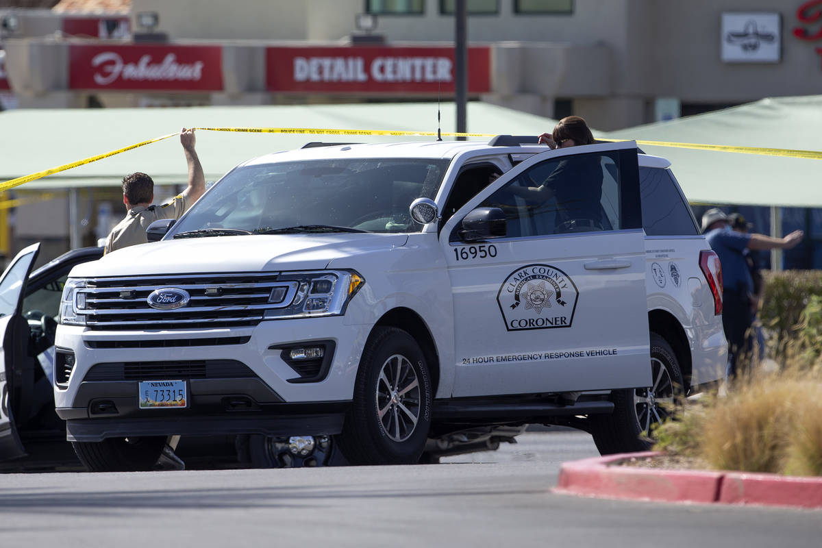 The Clark County Coronor leaves a scene where homicide detectives are helping to investigate af ...