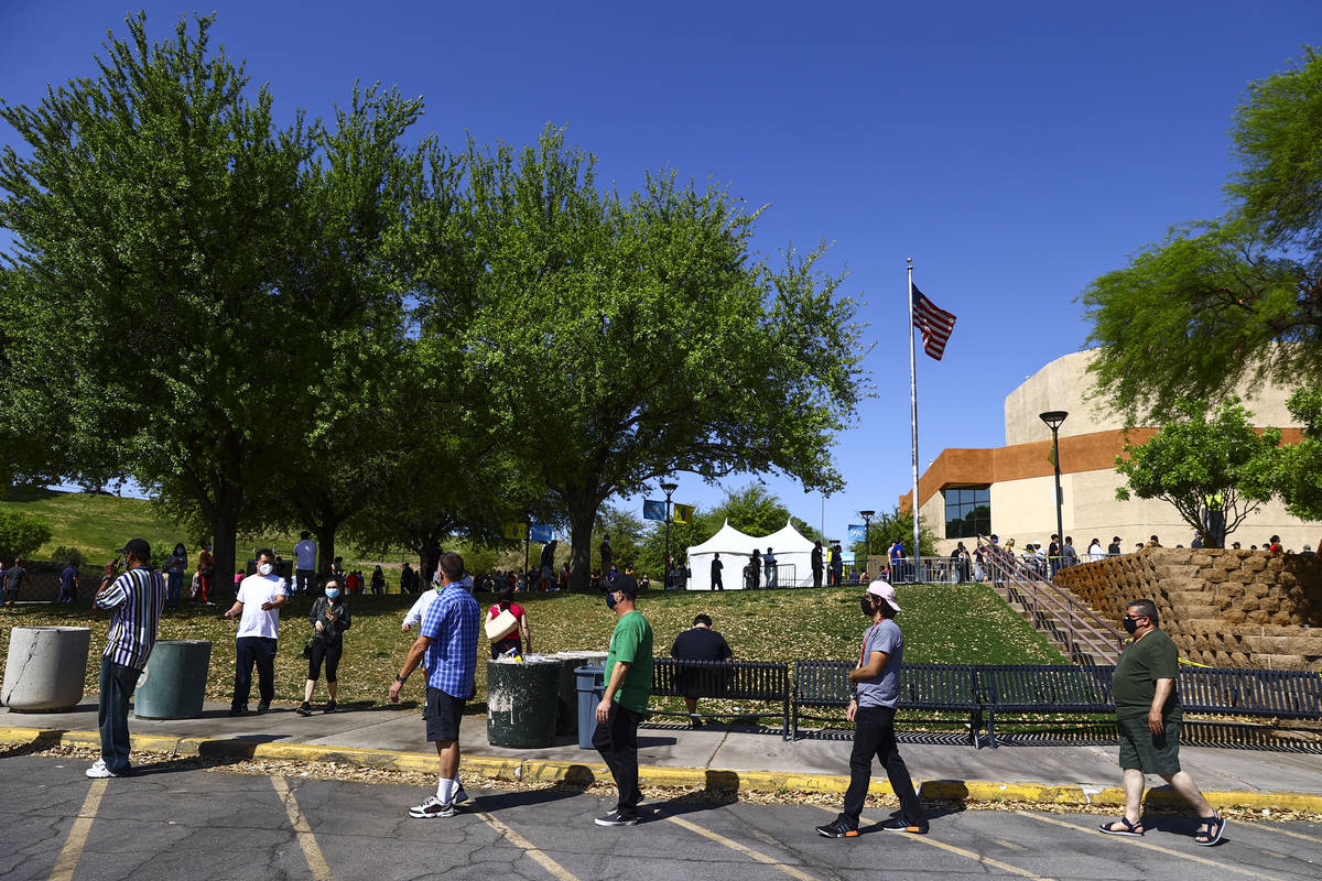 People wait in line at the COVID-19 vaccination site at Cashman Center in Las Vegas on Tuesday, ...