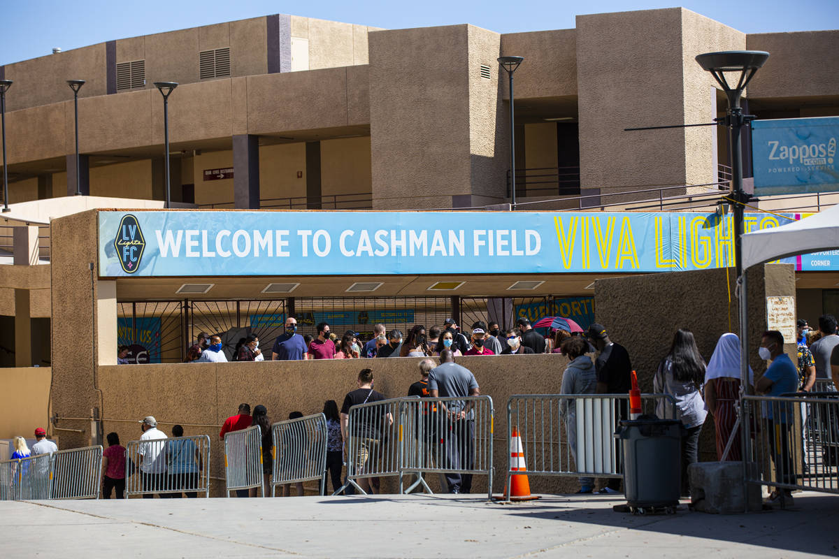 People wait in line at the COVID-19 vaccination site at Cashman Center in Las Vegas on Tuesday, ...