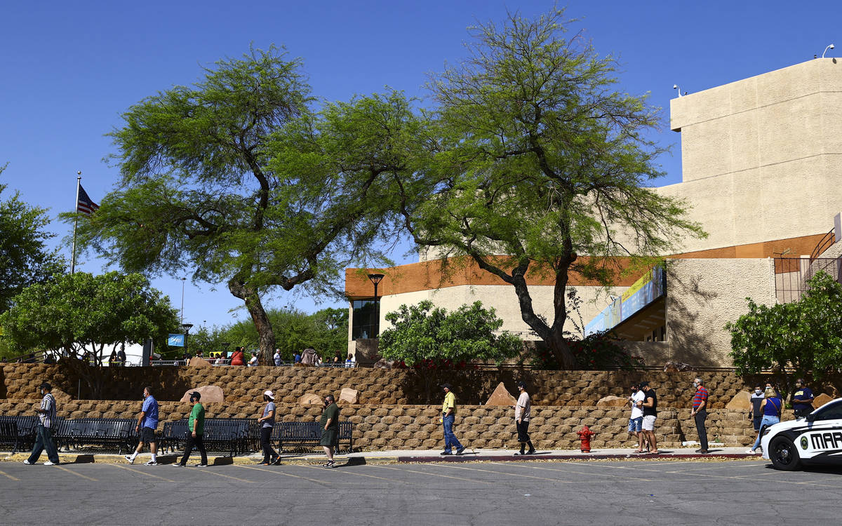 People wait in line at the COVID-19 vaccination site at Cashman Center in Las Vegas on Tuesday, ...