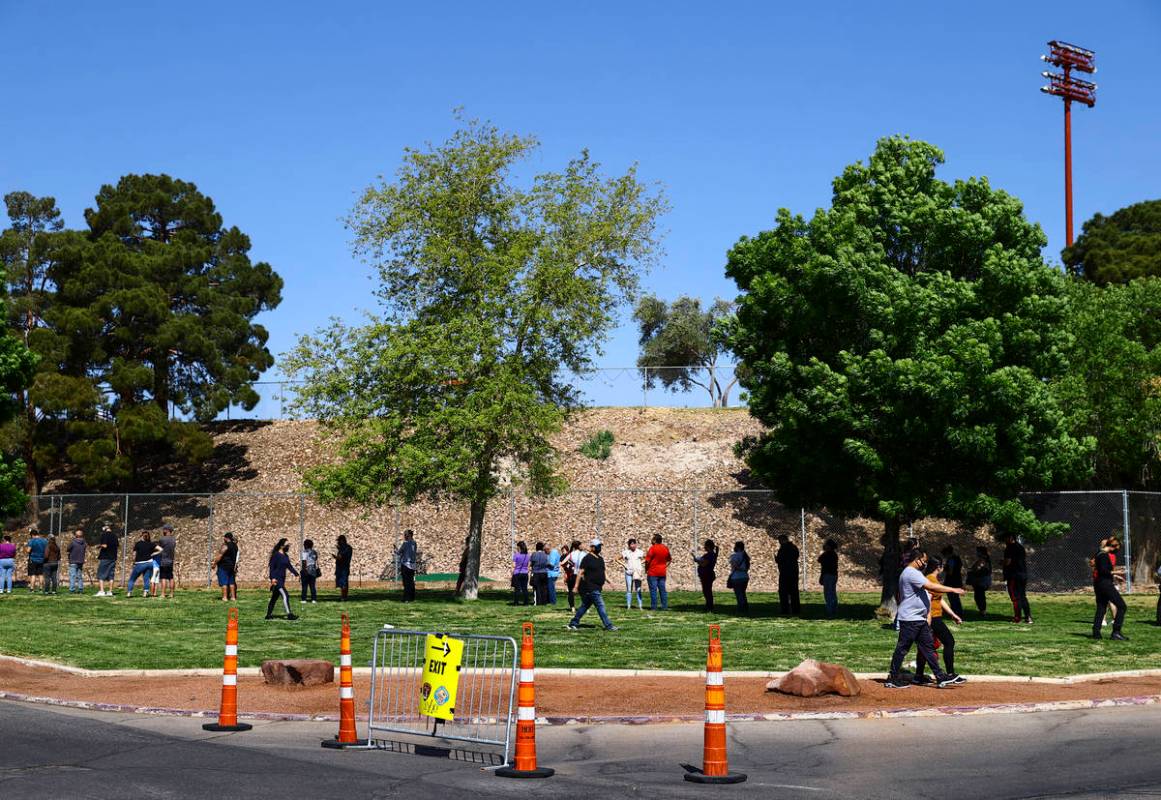 People wait in line at the COVID-19 vaccination site at Cashman Center in Las Vegas on Tuesday, ...