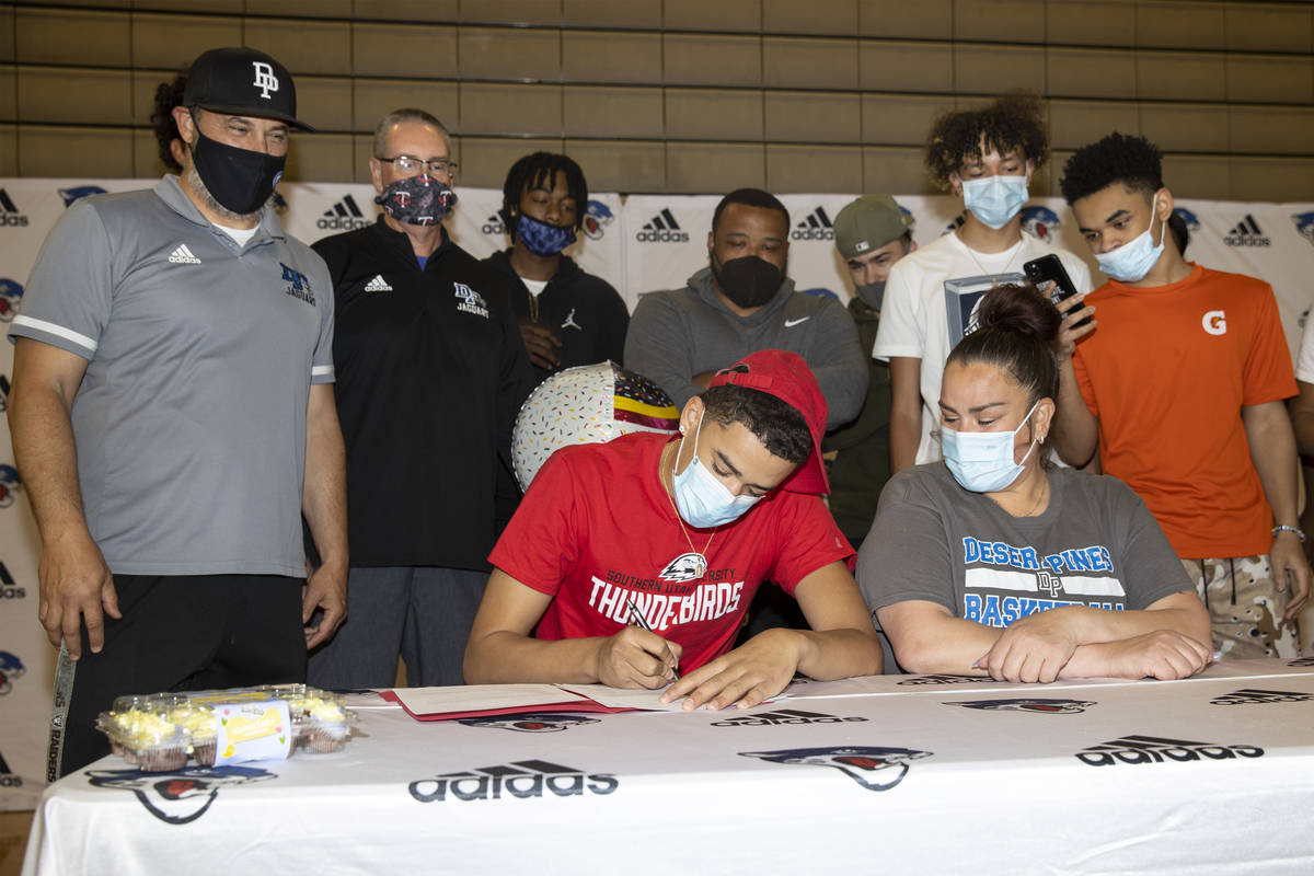 Desert Pines senior Anthony Swift, second from left, sits next to his mother Jay Douwes, during ...
