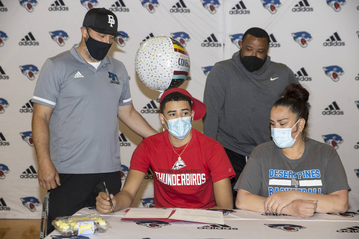Desert Pines senior Anthony Swift, second from left, sits next to his mother Jay Douwes, and co ...