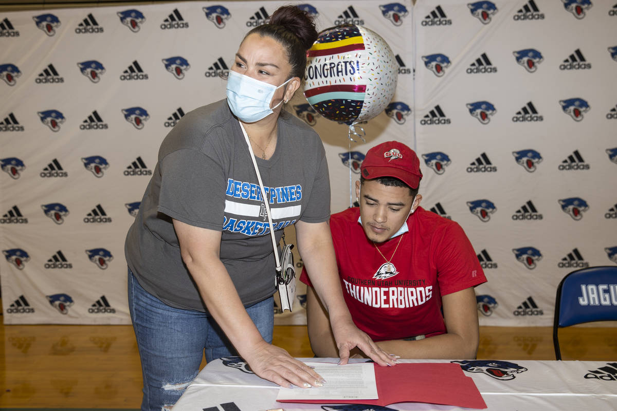 Desert Pines senior Anthony Swift, right, receives his commitment letter to Southern Utah Unive ...