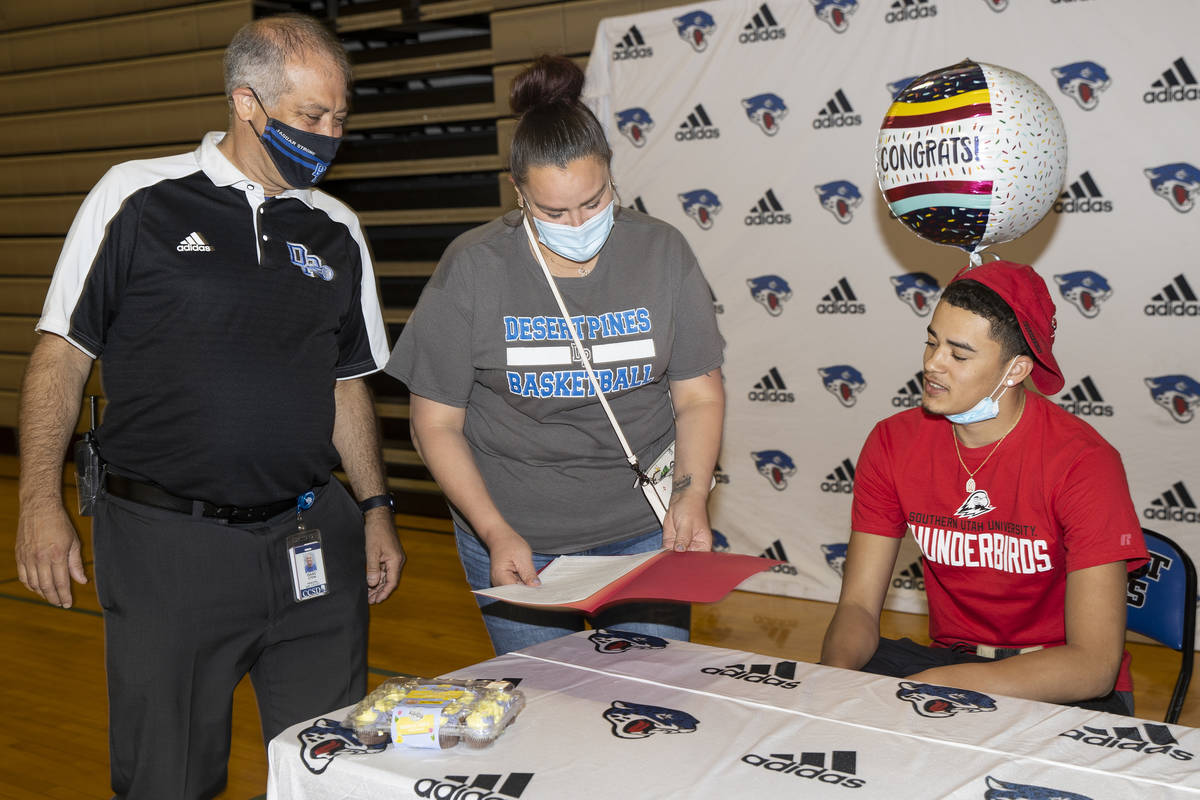 Desert Pines senior Anthony Swift, right, receives his commitment letter to Southern Utah Unive ...