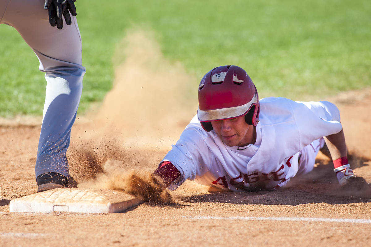 Arbor View's Tyler Whitaker slides in safe at first during the second inning while playing agai ...