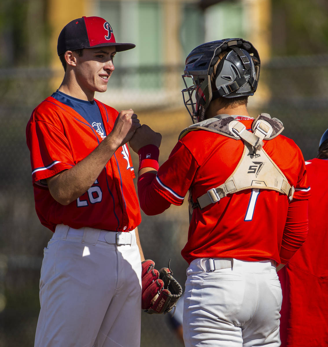 Liberty pitcher Ethan O'Neal (26) is encouraged by catcher Chase Gallegos versus Spring Valley ...