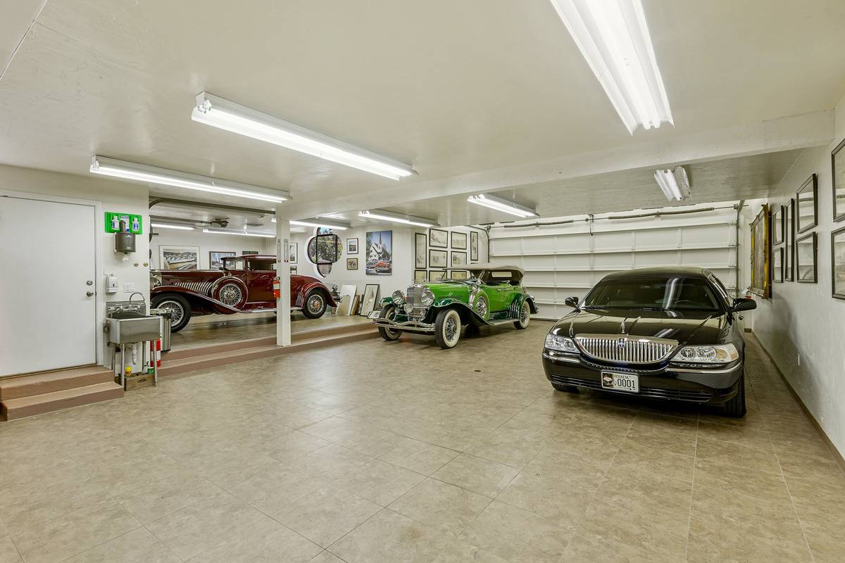 A six-car attached garage is augmented by a separate garage area that accommodates two more car ...