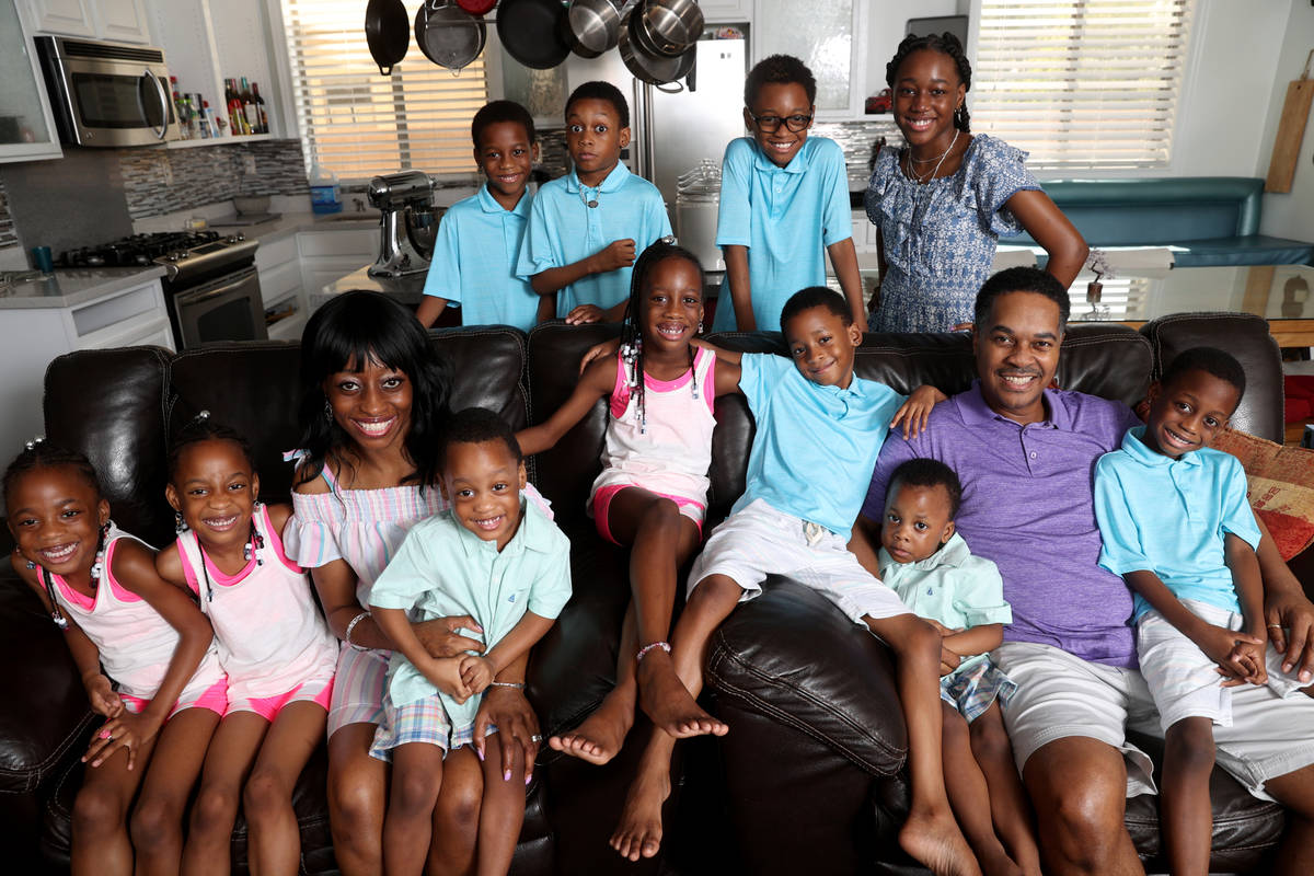 Deon and Karen Derrico with 12 of their 14 children at their North Las Vegas home Tuesday, Aug. ...