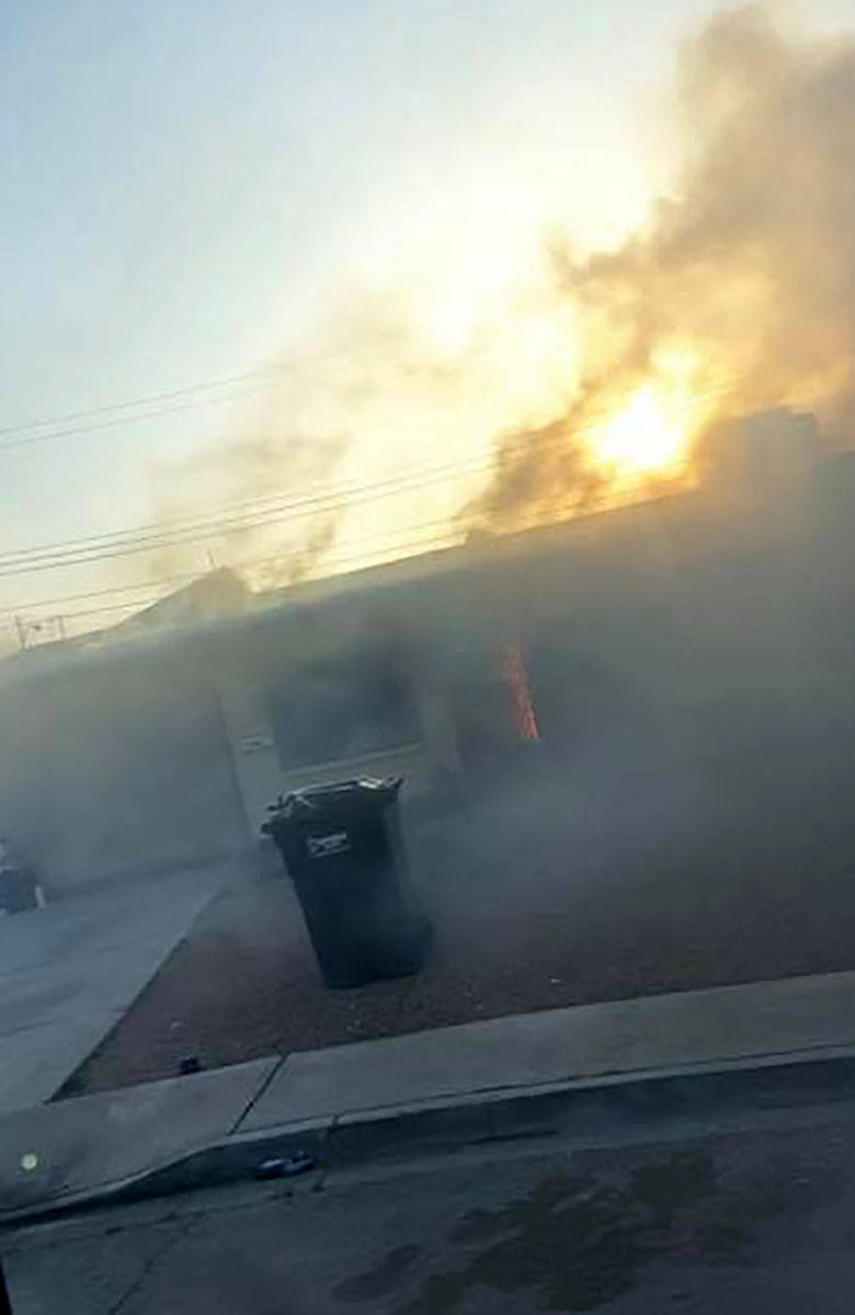 This photo released by North Las Vegas Fire Department shows smoke at a house on Webster Circle ...