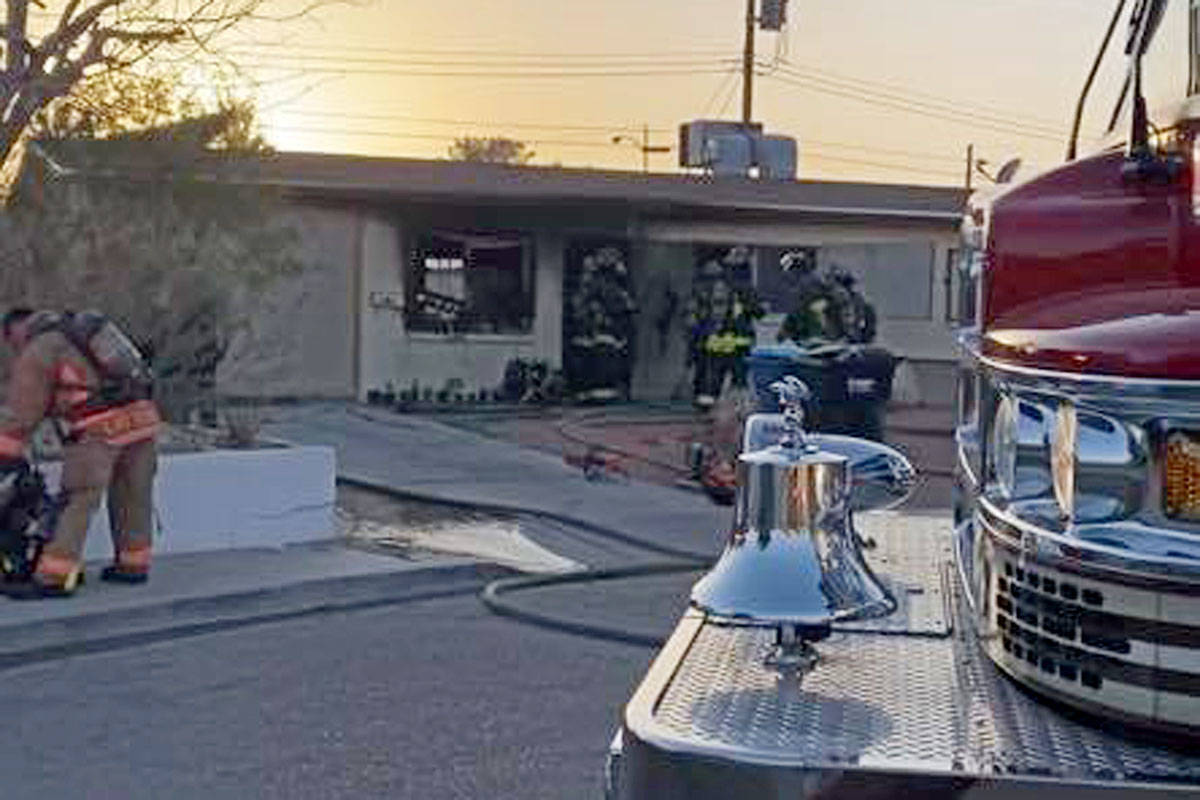 North Las Vegas firefighters investigate a house fire on Webster Circle in North Las Vegas on T ...