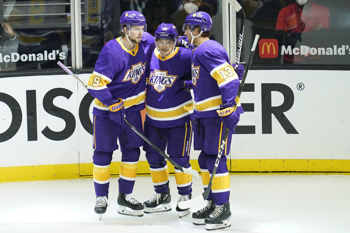 Los Angeles Kings center Trevor Moore (12) celebrates with right wing Adrian Kempe (9) and cent ...