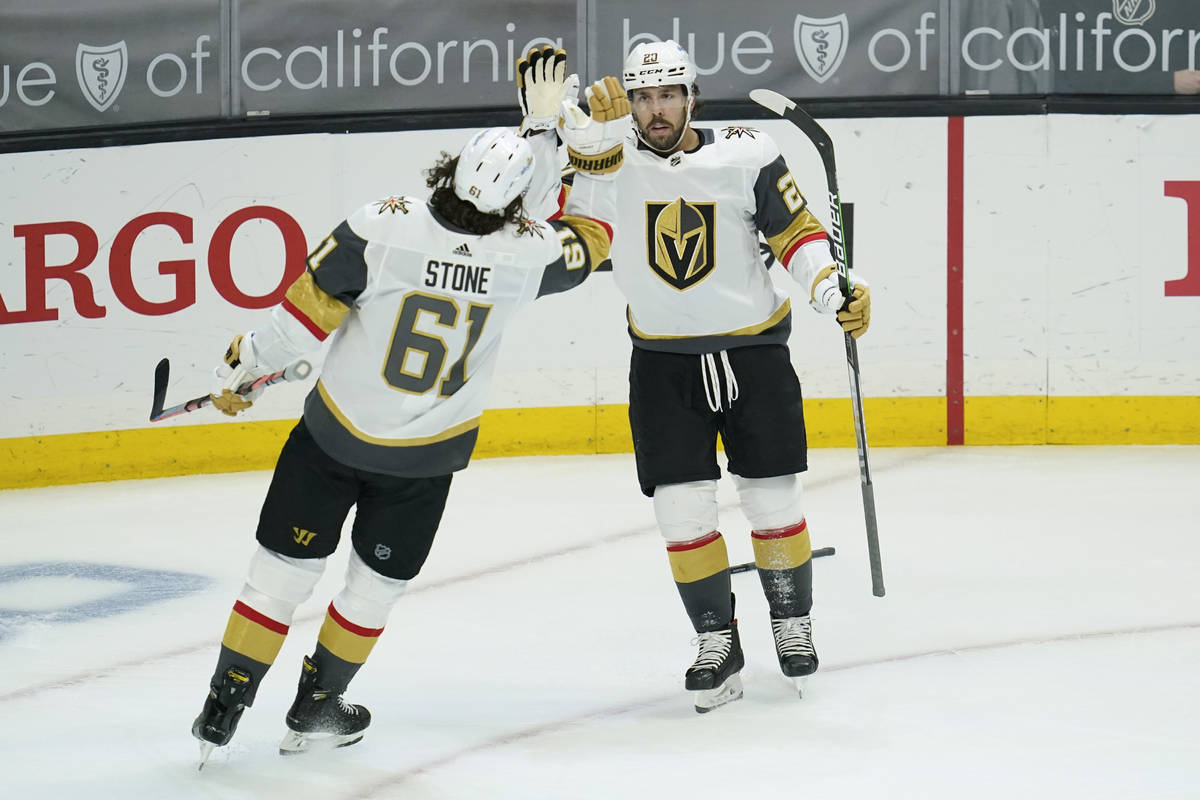 Vegas Golden Knights center Chandler Stephenson (20) high-fives right wing Mark Stone (61) afte ...