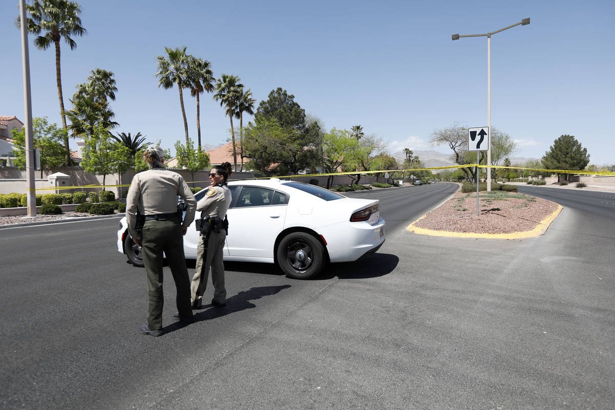 Police block a part of West Lake Mead Boulevard after a fatal car crash, Wednesday, April 14. 2 ...