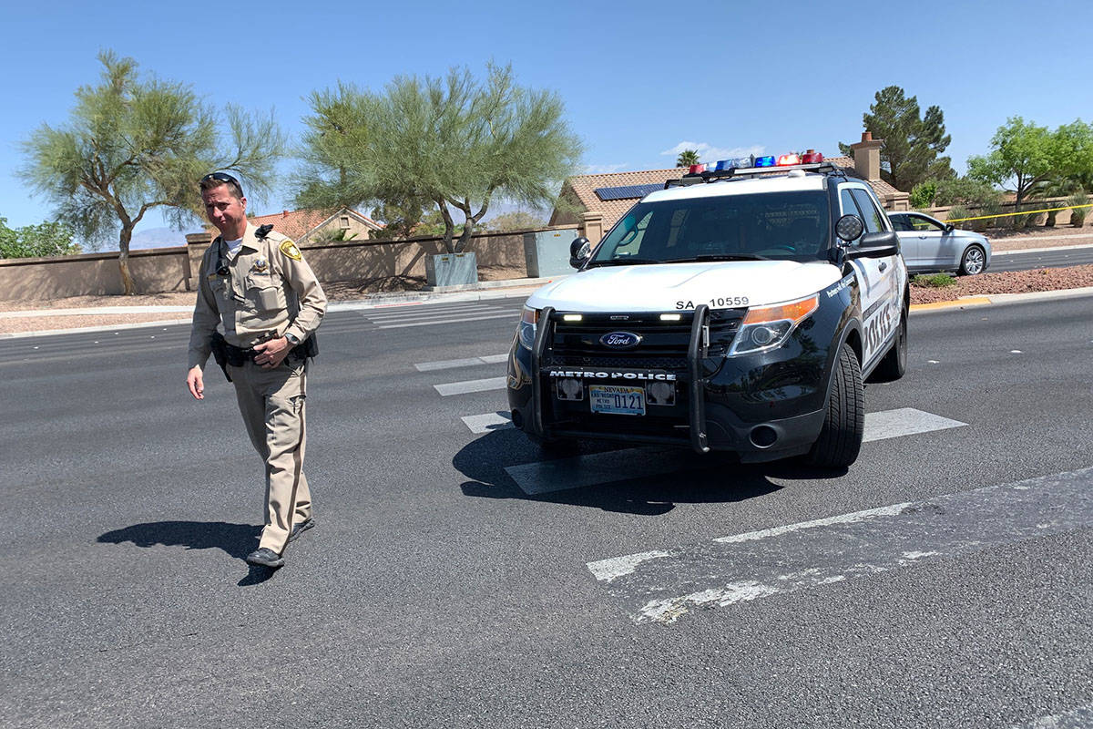 Police block a part of West Lake Mead Boulevard after a fatal car crash, Wednesday, April 14. 2 ...