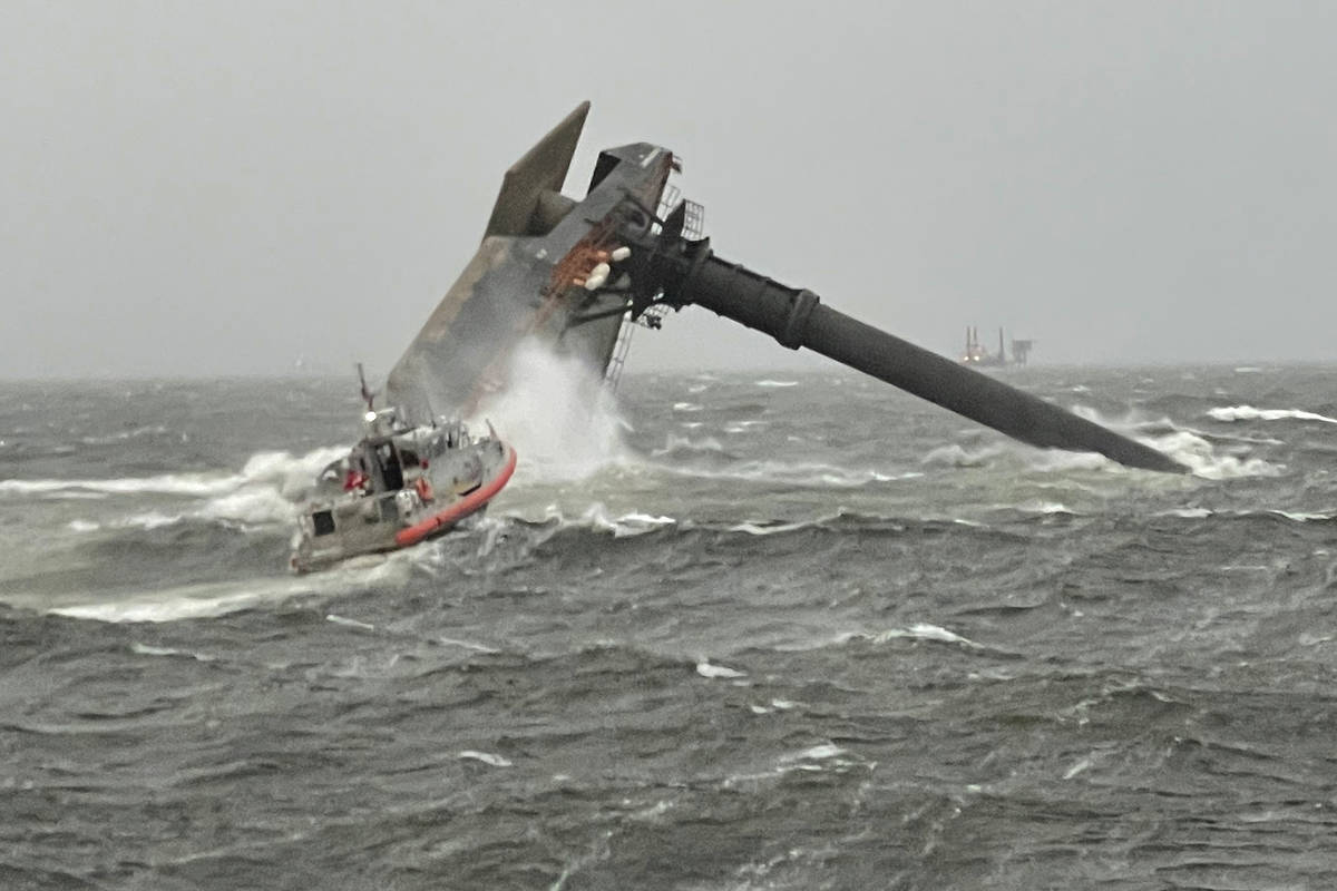 A Coast Guard Station Grand Isle 45-foot Respone Boat-Medium boatcrew heads toward a capsized 1 ...
