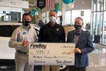 Mike Lubbe, center, president/CEO of YMCA Southern Nevada, accepts a donation check from Doug F ...