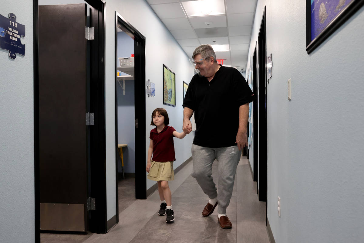Akara Haase, 6, leaves with her father Gary Haase after a session at the Center for Autism and ...