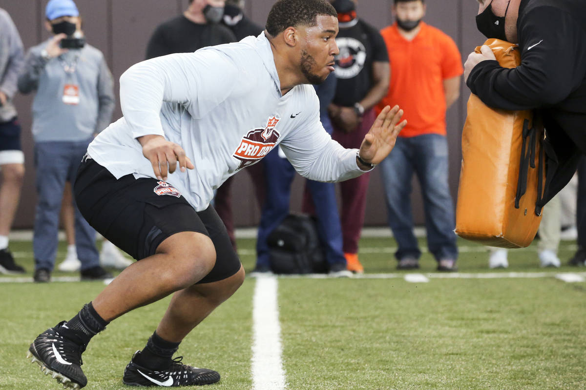 Christian Darrisaw runs a drill Virginia Tech pro day, attended by NFL football scouts, in Blac ...